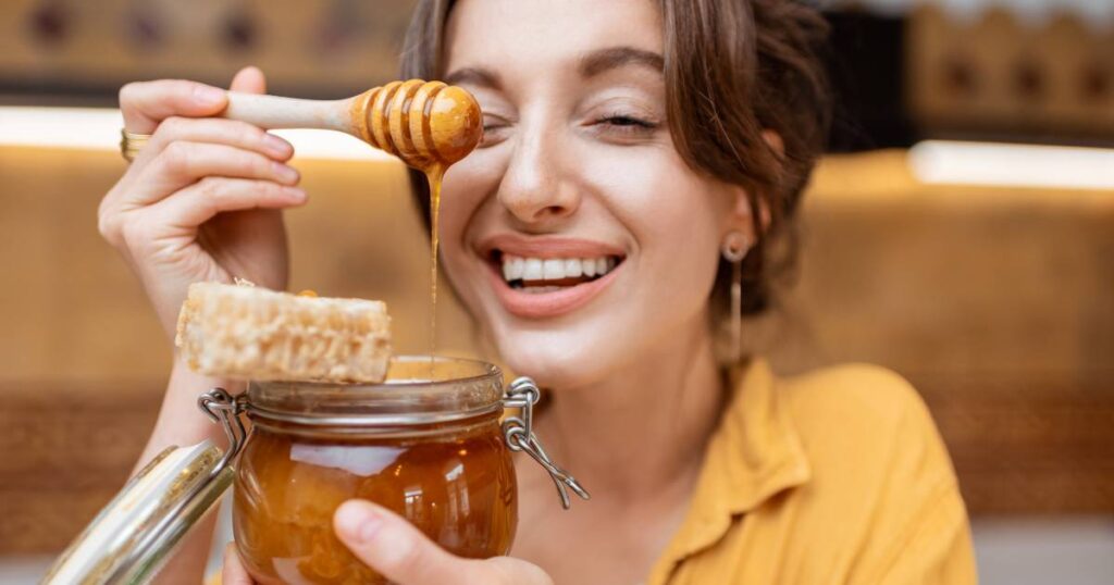 A woman with a jar of honey.
